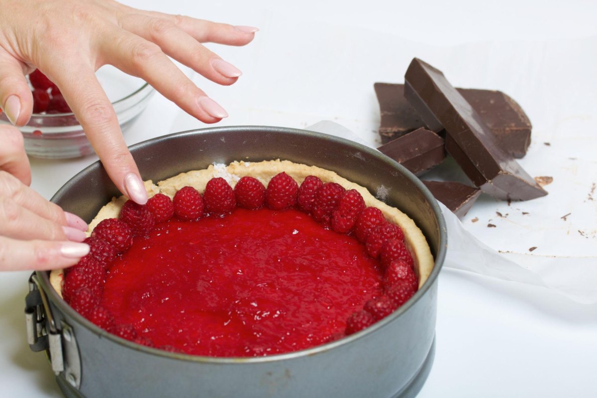 Himbeeren auf Kuchen verteilen